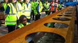 Callerton Academy students signing an exposed steel