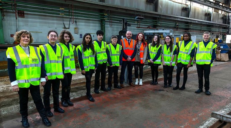 Callerton Academy students signing an exposed steel