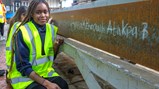 Callerton Academy students signing an exposed steel